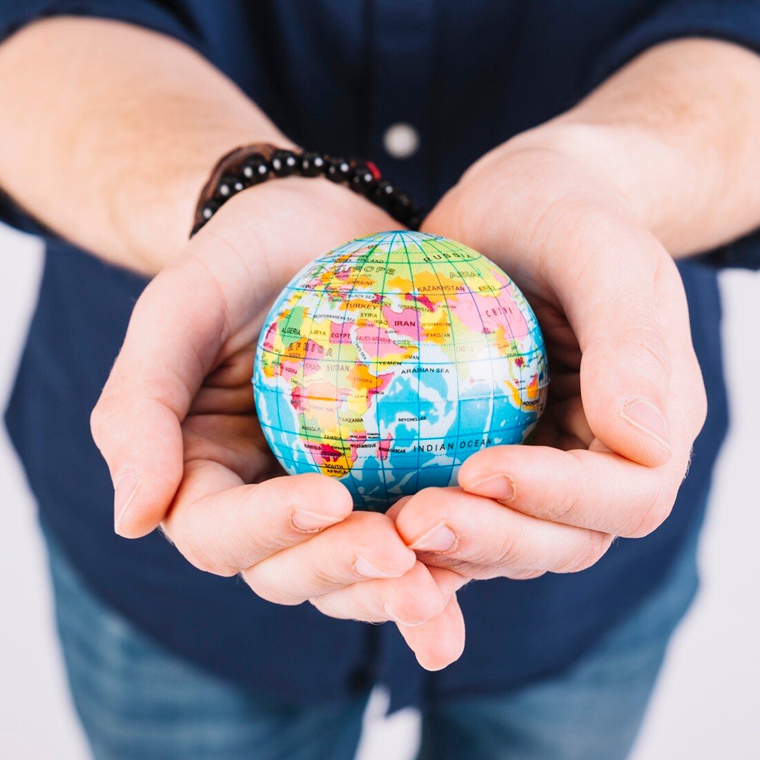 close-up-man-s-hand-holding-globe
