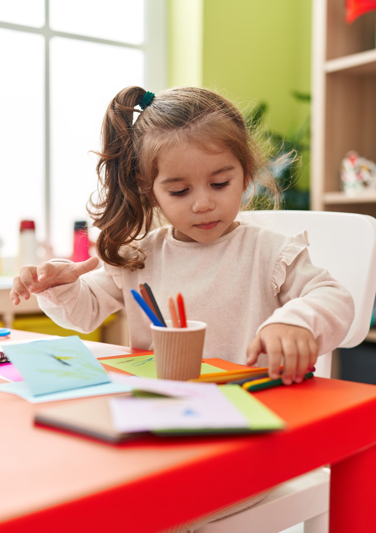 adorable-hispanic-girl-student-sitting-table-drawing-paper-kindergarten (1)