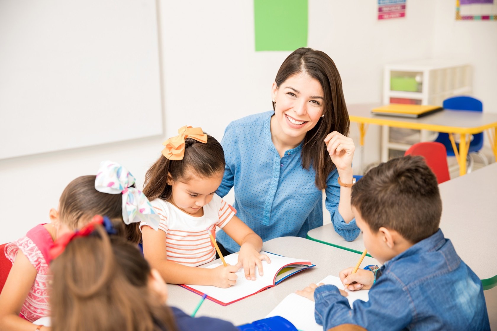 portrait-gorgeous-hispanic-preschool-teacher-teaching-her-students-classroom