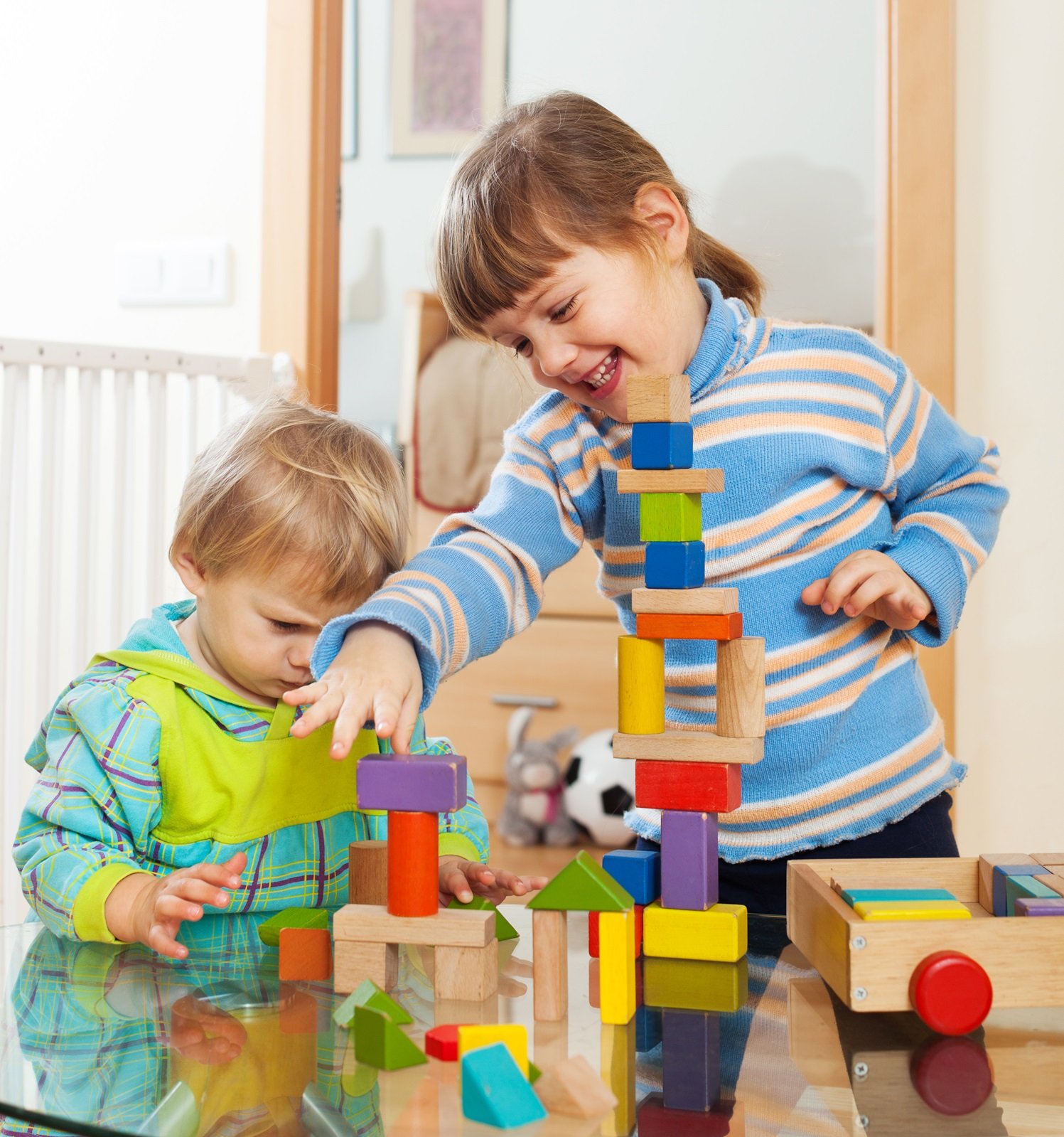 siblings-together-playing-with-toys